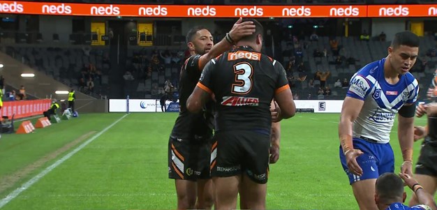 Joey Leilua fends his way over to get the Wests Tigers back level