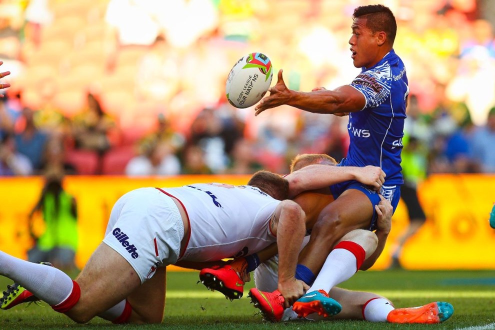 Sam Tagataese (R) gets a pass away as George Burgess (L) tackles during the Four Nations test match between England and Samoa at Suncorp Stadium,  Brisbane Australia on October 18, 2014.