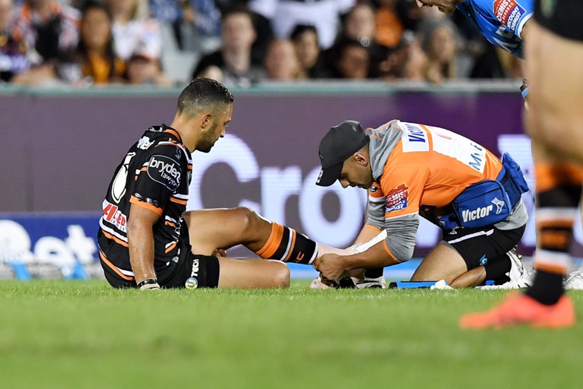 Benji Marshall gets treatment on his ankle in Wests Tigers Round 3 match against Brisbane.