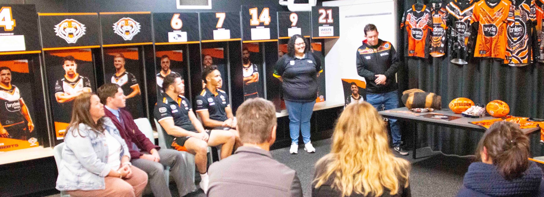 Indigenous students with James Roberts and Daine Laurie in Wests Tigers changeroom