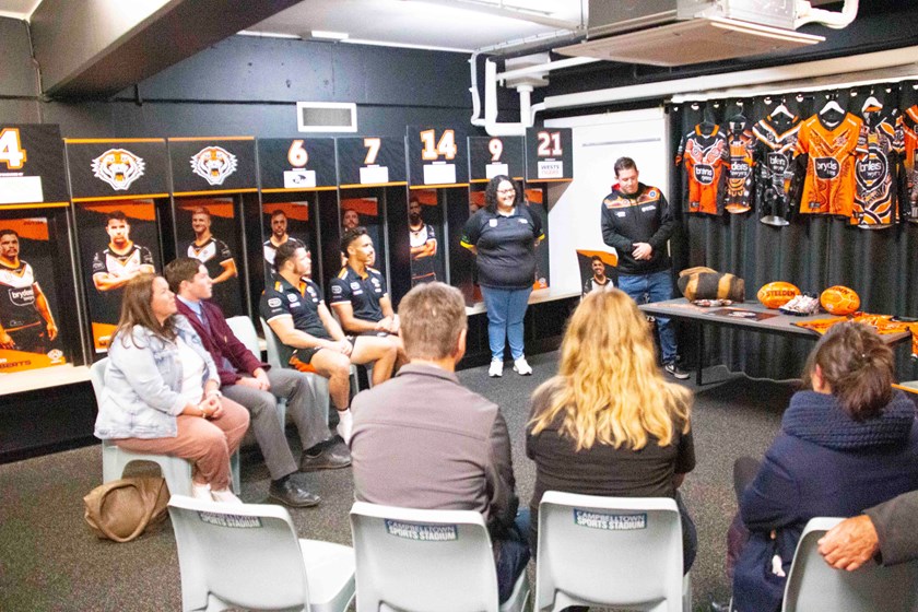 Indigenous students with James Roberts and Daine Laurie in Wests Tigers changeroom