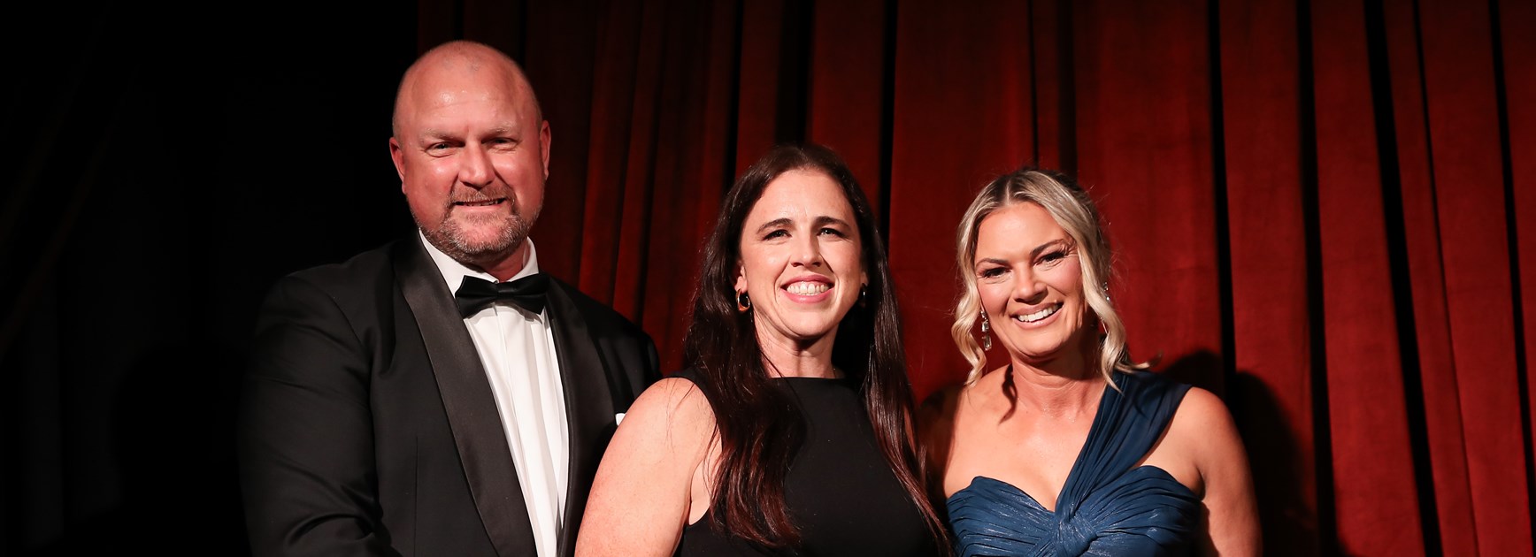 2026 Wests Tigers Club Person of the Year,  Emma Forster (centre), with CEO Shaun Mielekamp, and Charmain Steventon, Head of Women’s Football, after receiving her award