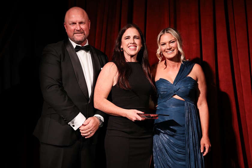 2026 Wests Tigers Club Person of the Year,  Emma Forster (centre), with CEO Shaun Mielekamp, and Charmain Steventon, Head of Women’s Football, after receiving her award