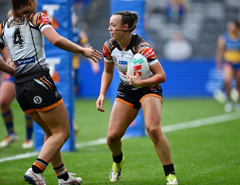 Over she goes...Caitlin Turnbull celebrates her try in the round one win over the Eels