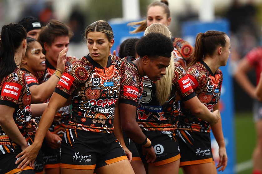 Wests Tigers players celebrate the try of five-eighth Losana Lutu 