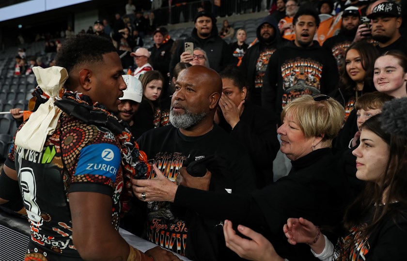Proud moment..Joey Saukuru embraces his son after his NRL debut